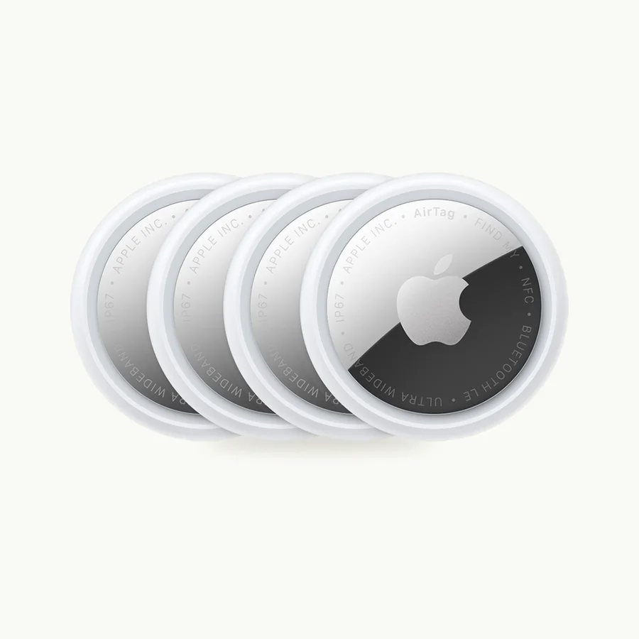 AirTag 4-Pack: Four white and silver AirTags fanned out in a row
